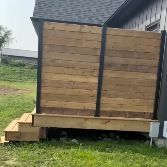 Cedar and steel privacy screen with built-in deck steps