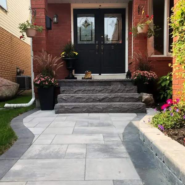 Natural-stone steps and paver walkway to a front door
