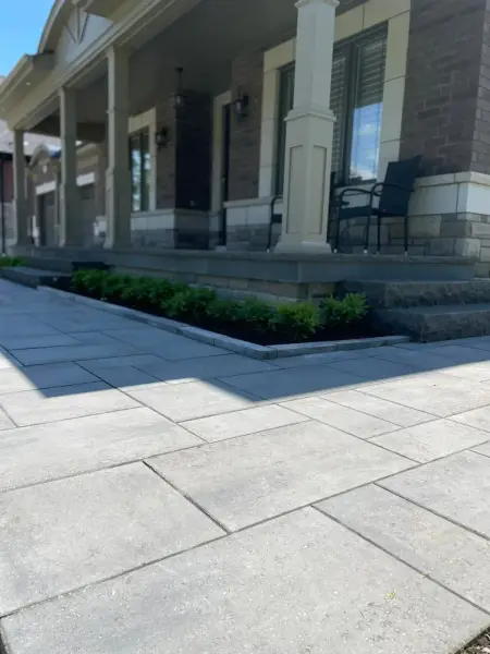 Paver walkway and planting bed along the drive