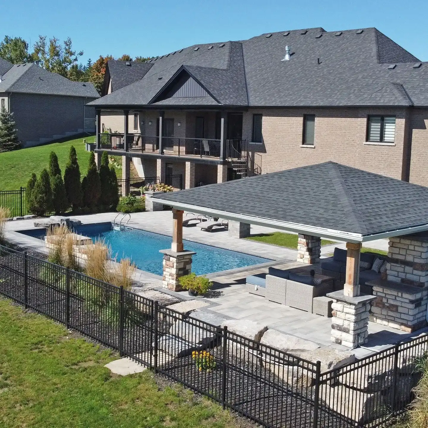 Aerial view of a backyard pool and pavilion