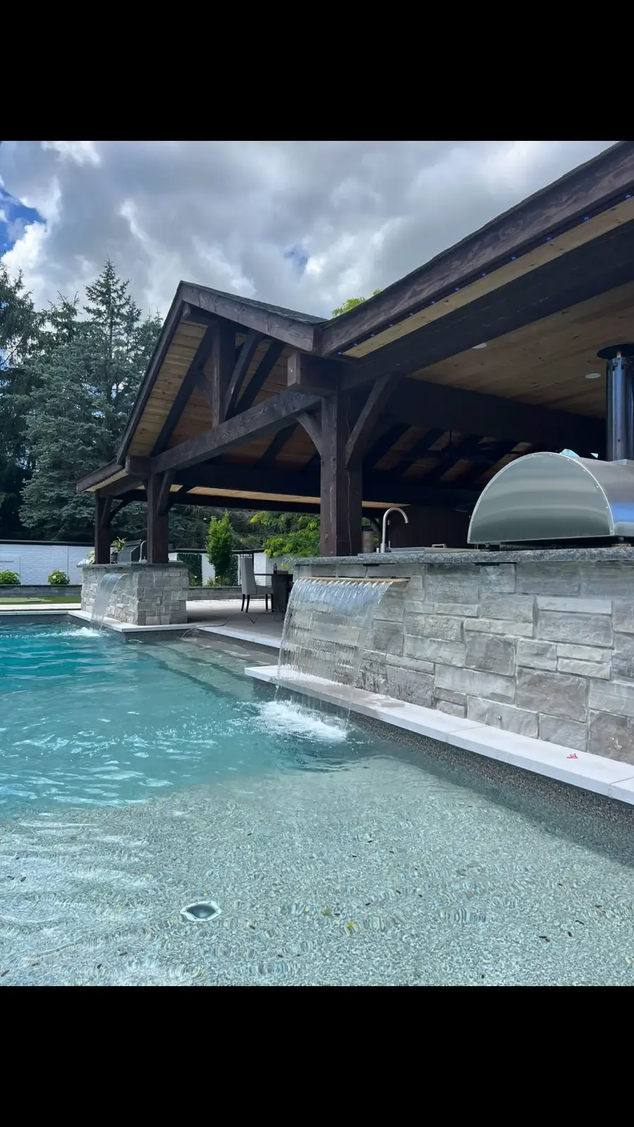 Timber pavilion beside a pool