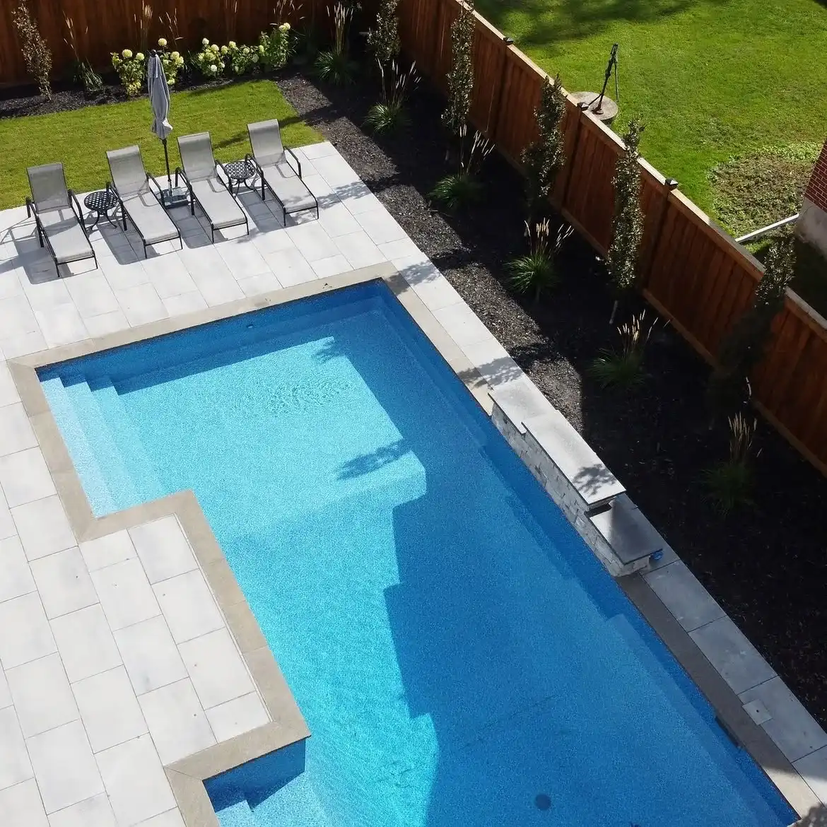 Overhead view of a rectangular pool and paver patio