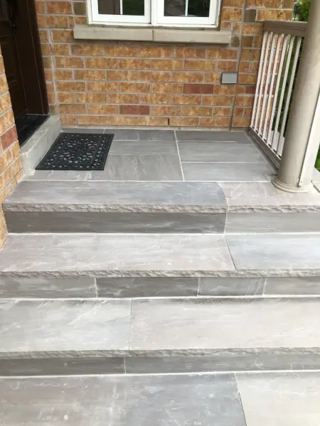 Large-format paver landing at a side entrance