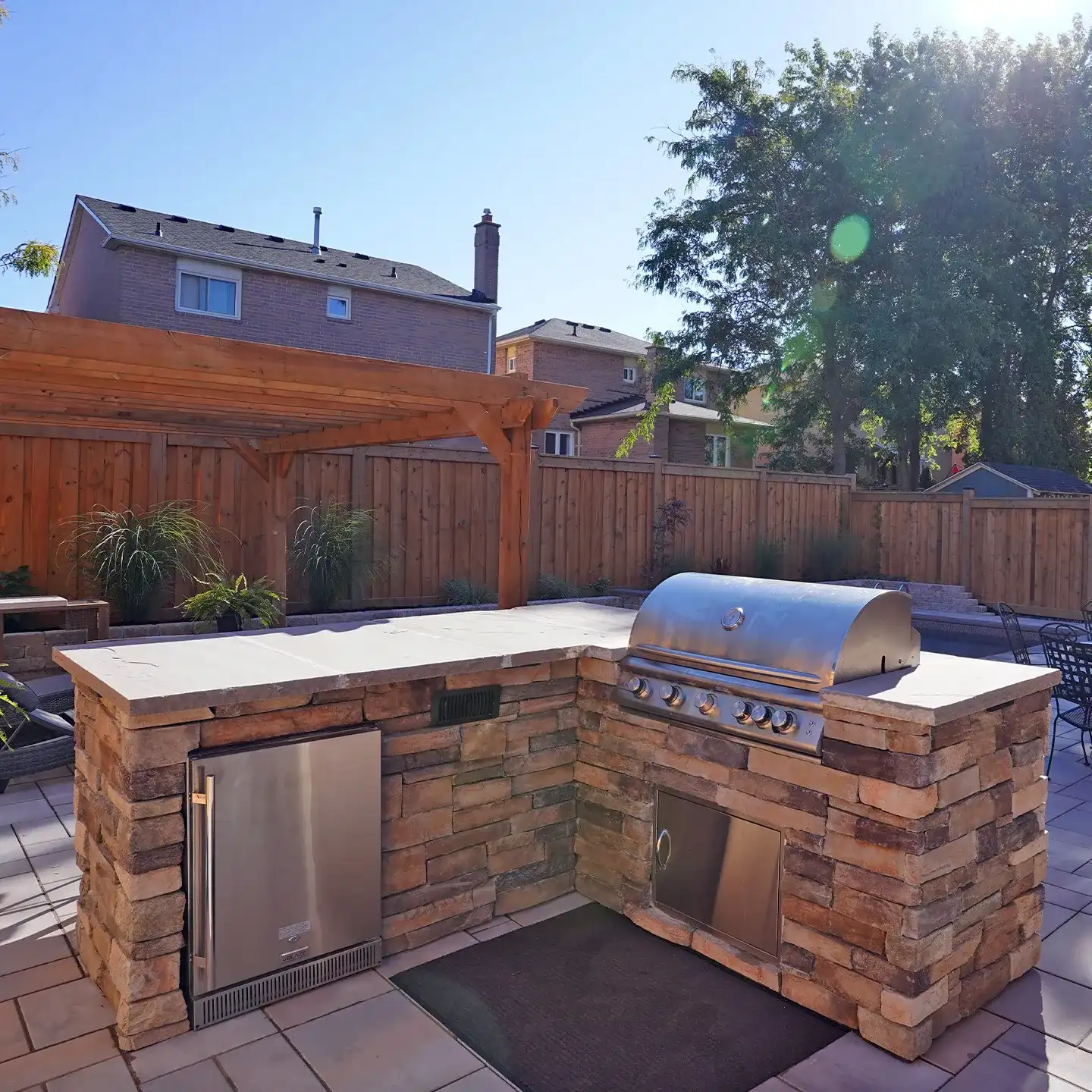 U-shaped outdoor kitchen in natural stone